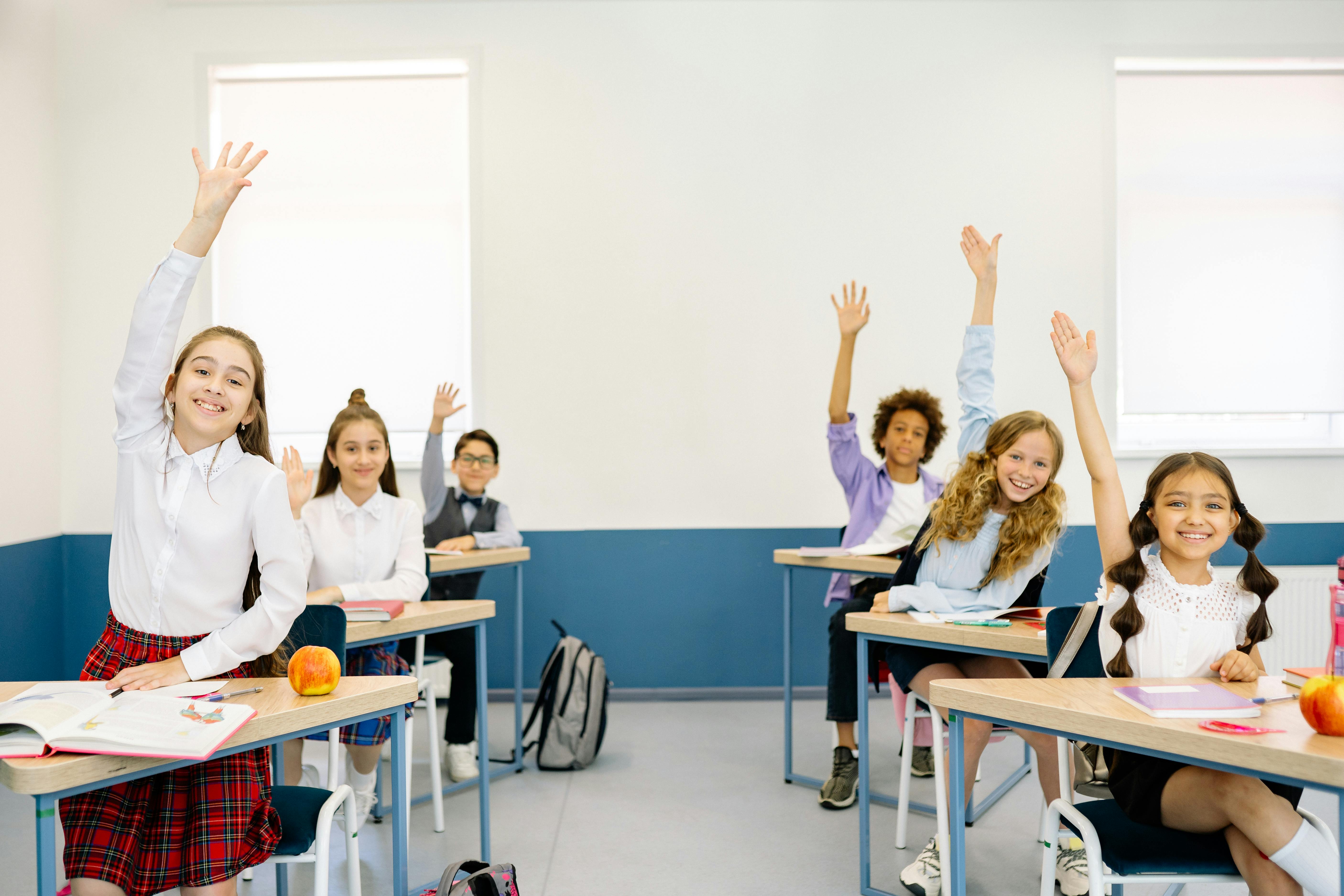 Happy students learning together in class